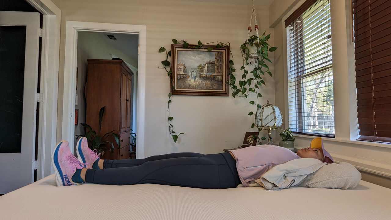 Our tester lying on the Essentia Stratami organic mattress to test its comfort and support