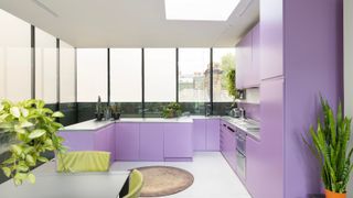 A purple wrap around kitchen with steel countertops