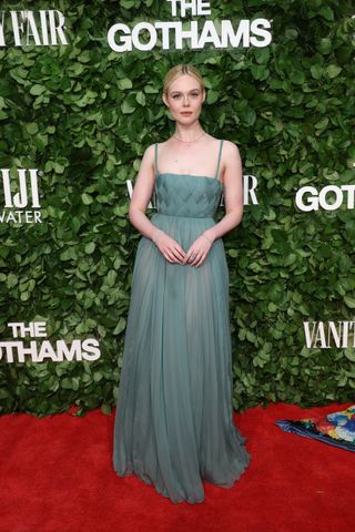 Elle Fanning on the Gotham Awards red carpet wearing a semi sheer green dress