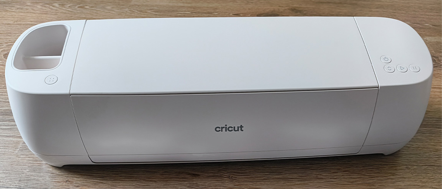 Cricut Explore 4 review: a white craft machine on a wooden table