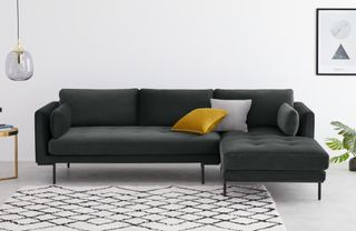 A high-legged chaise sofa in dark grey upholstery