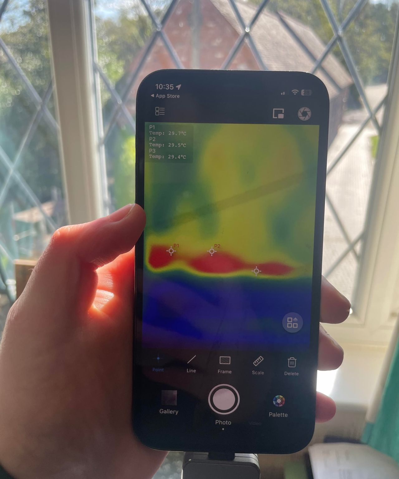 A thermal camera showing heat being lost on an Edwardian window