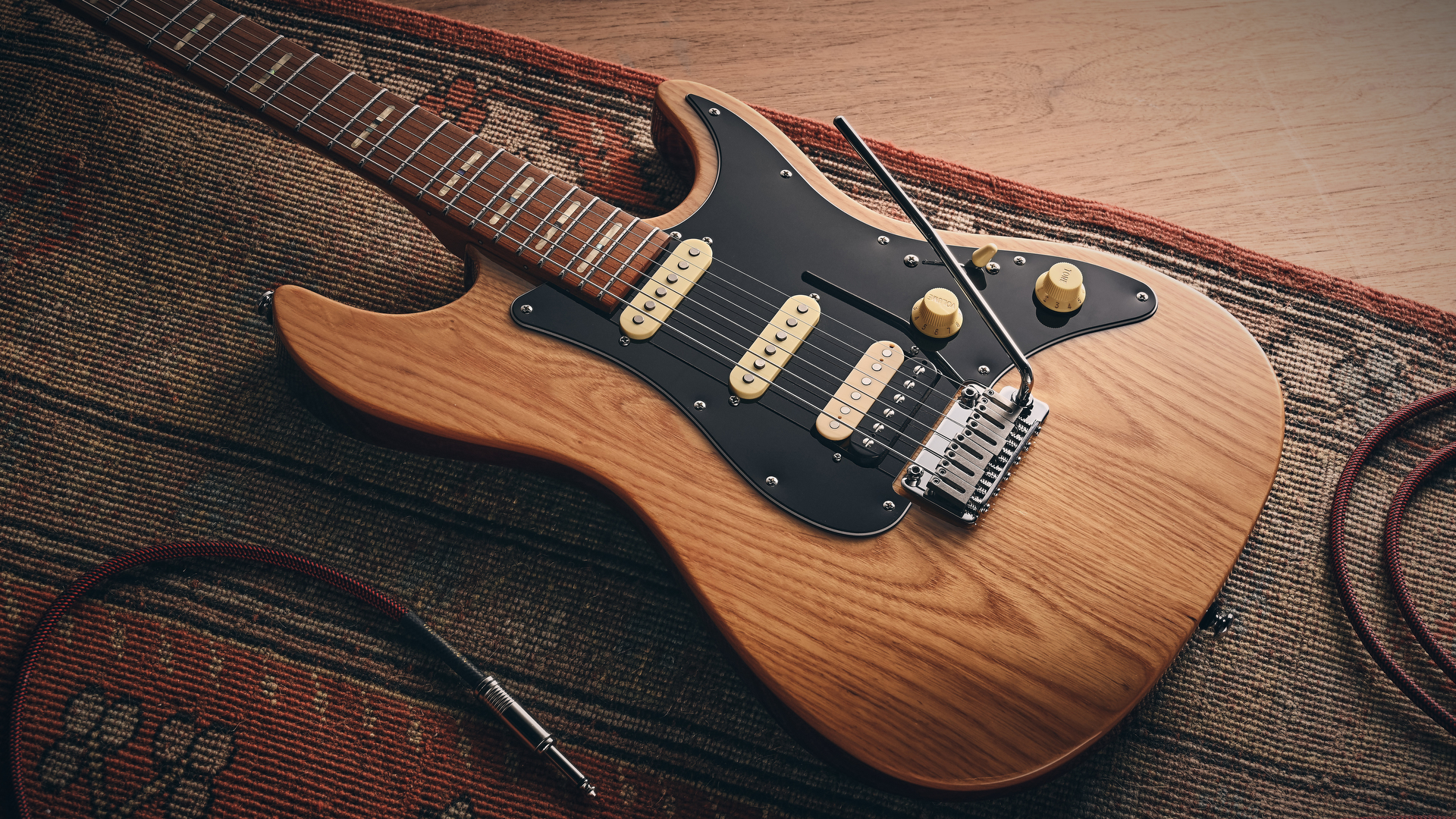 A Sire Larry Carlton S7 Ash Top electric guitar lying on a rug