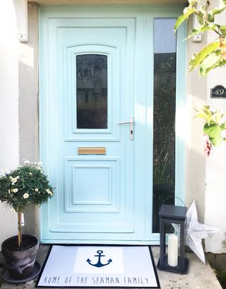 front door with duck egg color and plant in pots