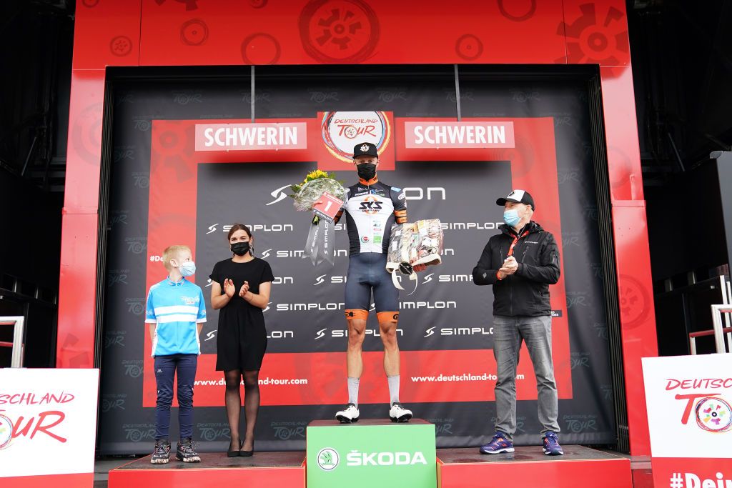 SCHWERIN GERMANY AUGUST 26 Jon Knolle of Germany and Team Sks Sauerland Nrw celebrates winning the Most Combative Rider Trophy on the podium ceremony after the 35th Deutschland Tour 2021 Stage 1 a 191km stage from Stralsund to Schwerin DeineTour on August 26 2021 in Schwerin Germany Photo by Christian KasparBartkeGetty Images