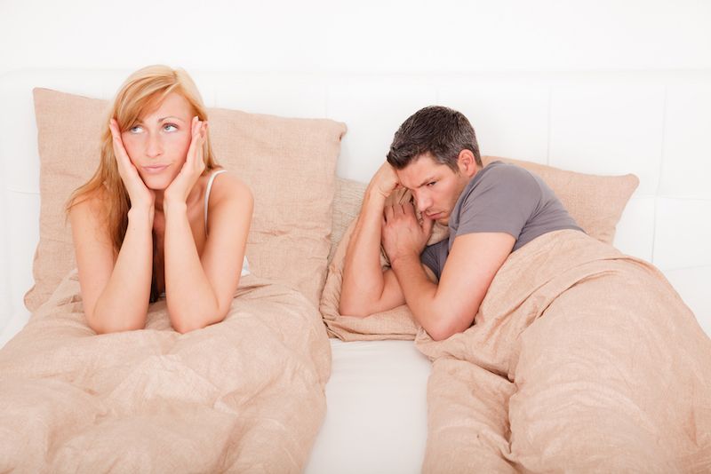 bored couple in bed