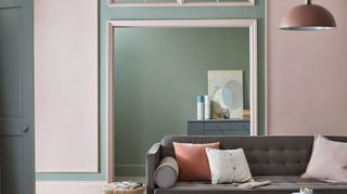 Alcove living room paint ideas, shown in mint green in a pale pink scheme with gray sofa.
