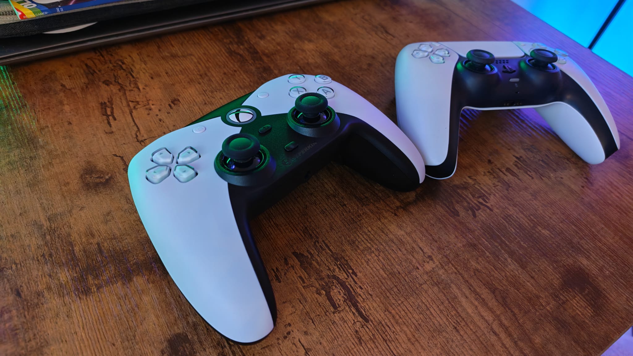 A white Hyperkin Competitor sitting next to a DualSense