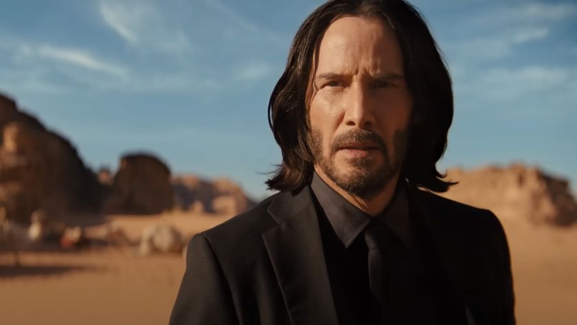 Keanu Reeves as John Wick in the desert in Chapter 4 looking straight at the camera.