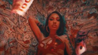 Bhad Bhabie in Miss Understood music video with money floating around.