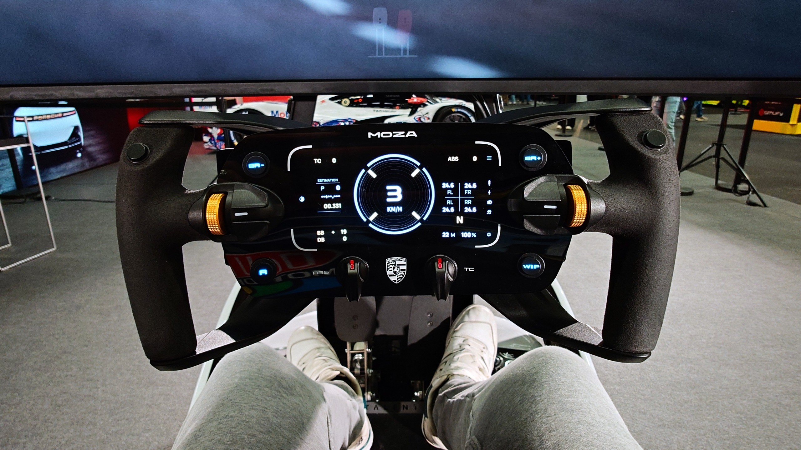 A photo of a Moza Porsche racing sim wheel from the POV of driving the ImSim Porsche Raceborn simulator.