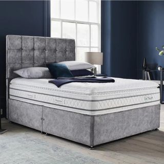 grey bed frame with white mattress on top