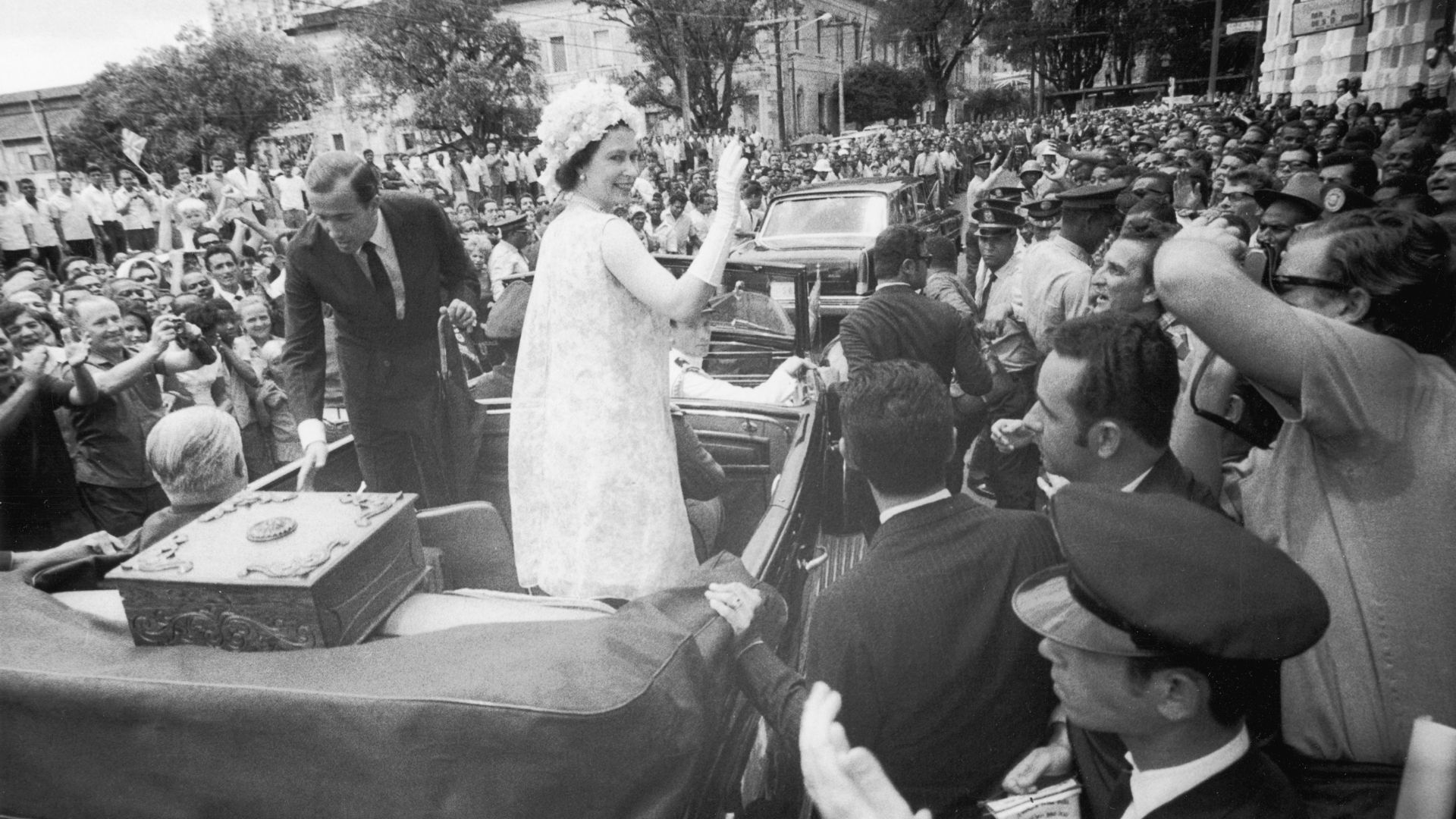 Queen Elizaeth II rides in an open car in South America