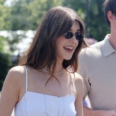 Daisy Edgar wears a matching linen set and carries a Gucci straw bag at Wimbledon