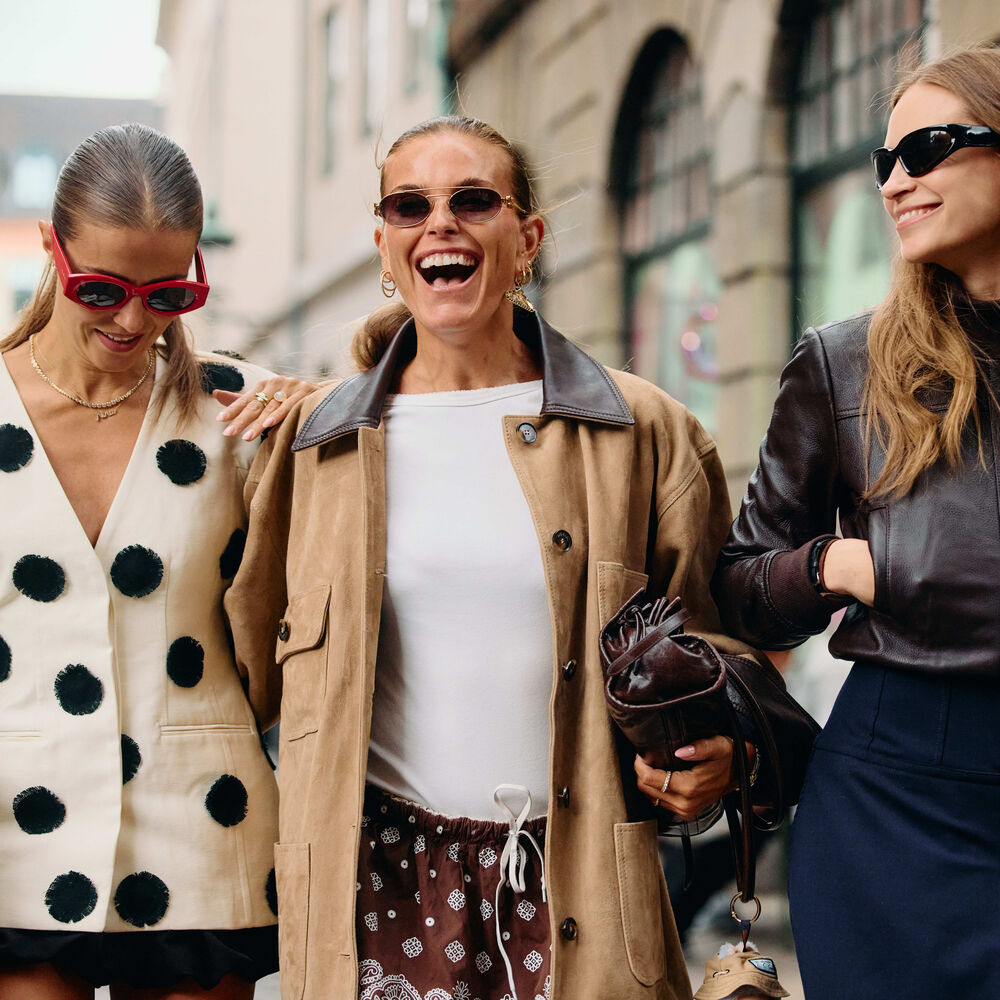 Three woman walking at Copenhagen fashion week. 