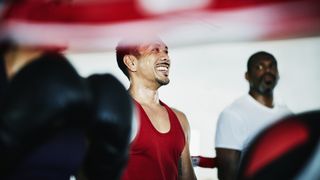 person smiling in a boxing ring