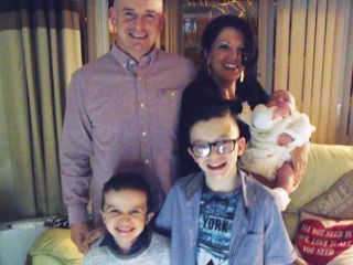 Sean McGrotty, with his partner Louise holding their baby, four-month-old Rionaghac-Ann and his sons Mark, 12, (right) and Evan, eight