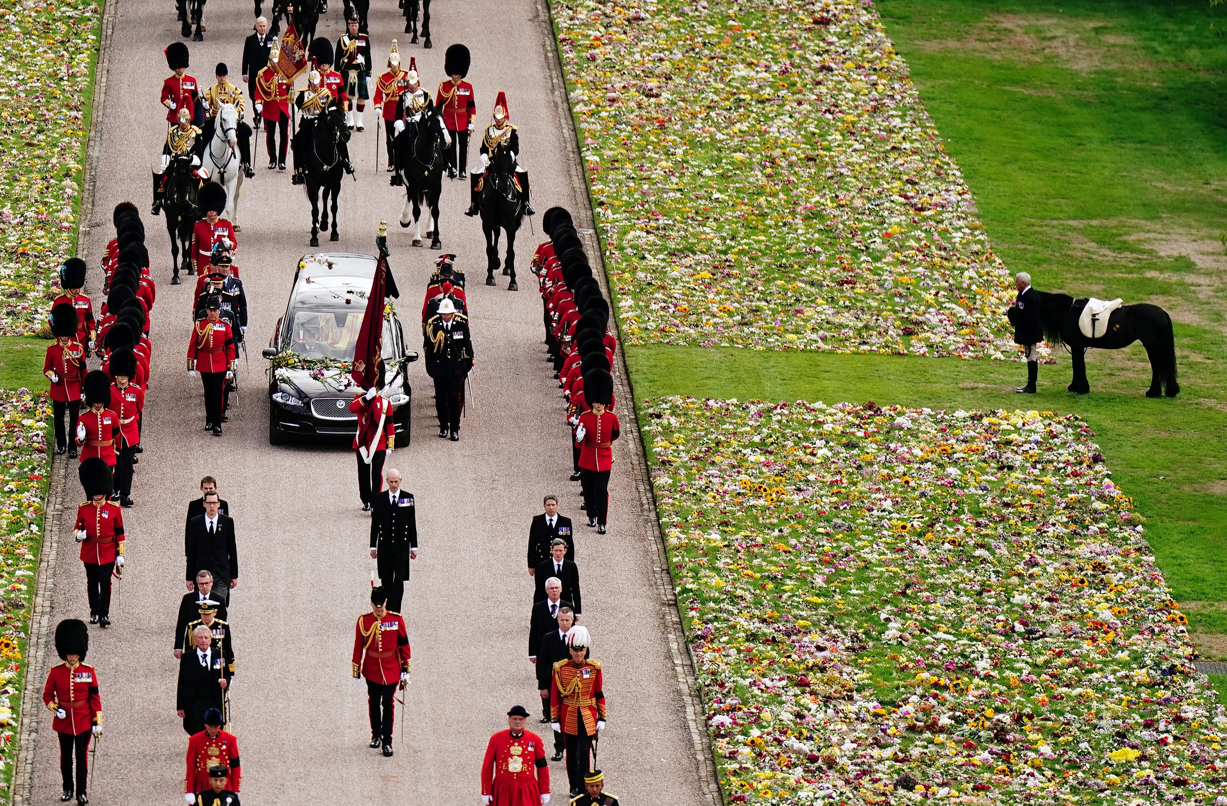 Queen Elizabeth's casket driving down the Long Walk in Windsor with her pony Emma watching on