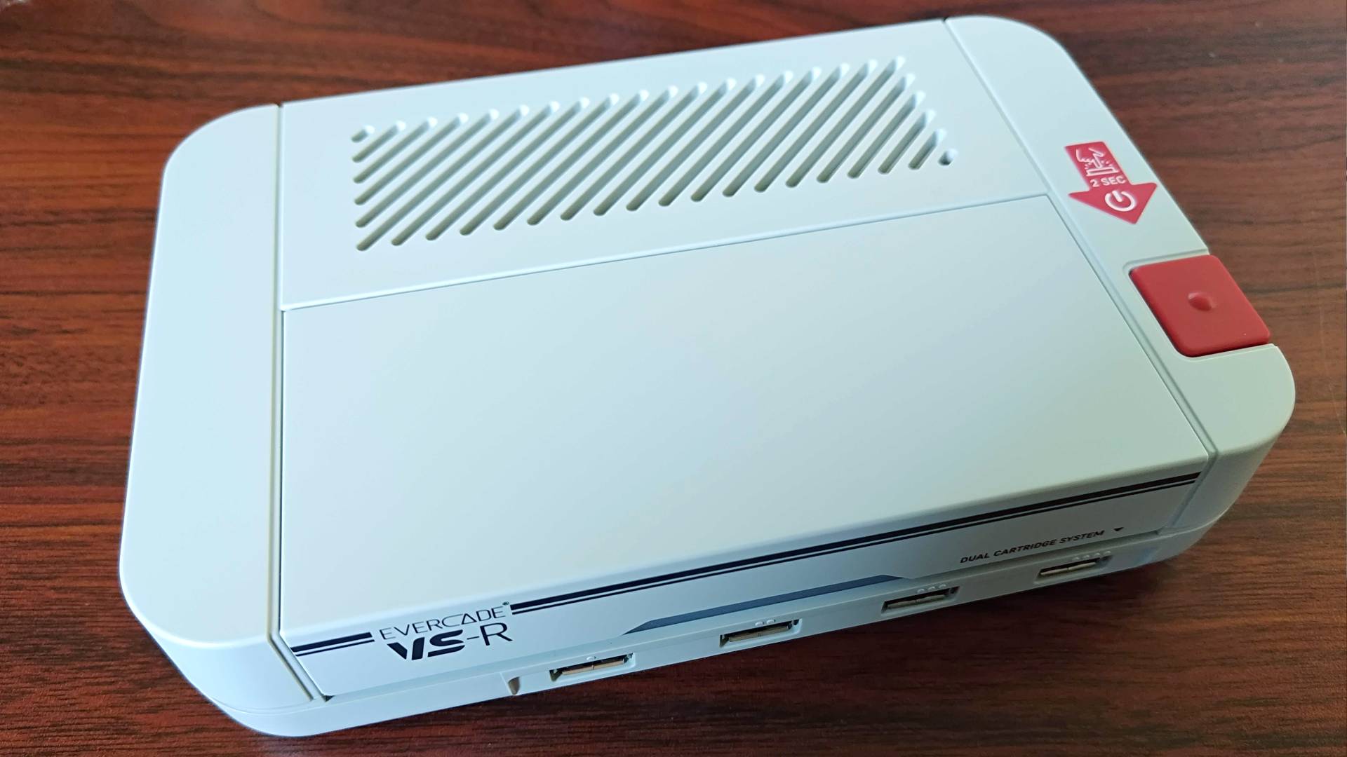 Evercade VS-R console on woodgrain desk.