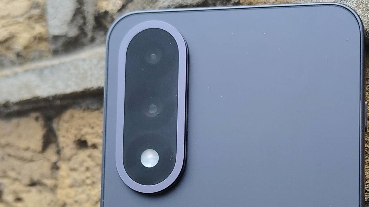 The OnePlus Nord 5 against a brick wall.