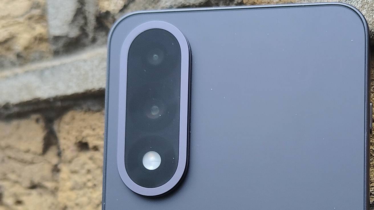 The OnePlus Nord 5 against a brick wall.