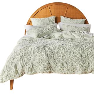 Anthropologie Textured Piazza Quilt on wooden bed frame with half moon headboard