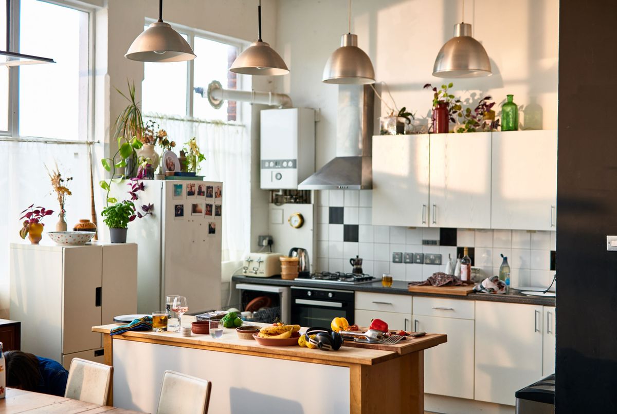 A kitchen with electrical appliances on the sides