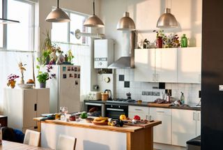 A kitchen with electrical appliances on the sides