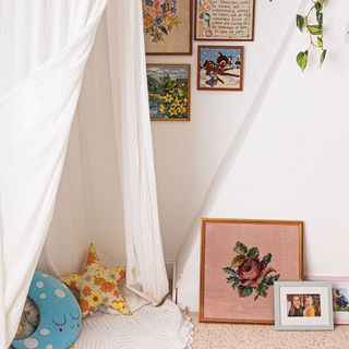 small nursery with reading nook under fabric canopy