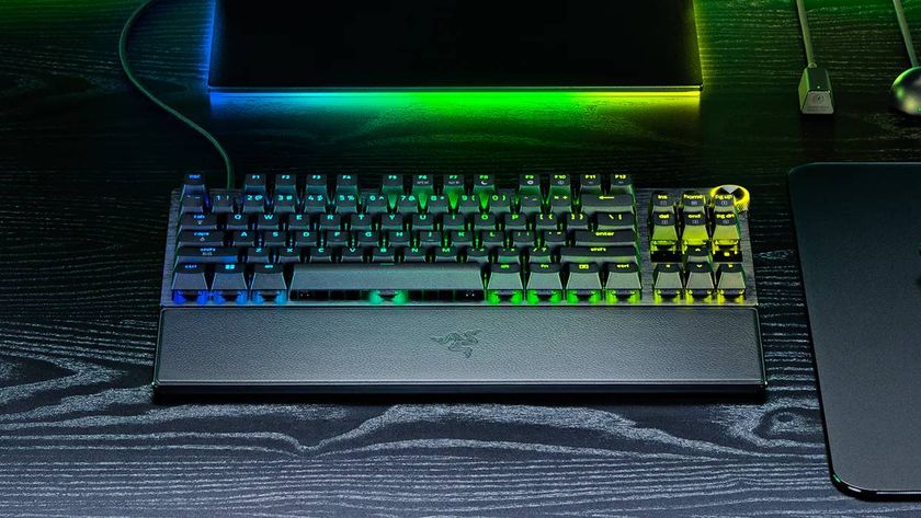 A press image of the Razer Huntsman V3 Pro 8KHz on a dark wooden desk.