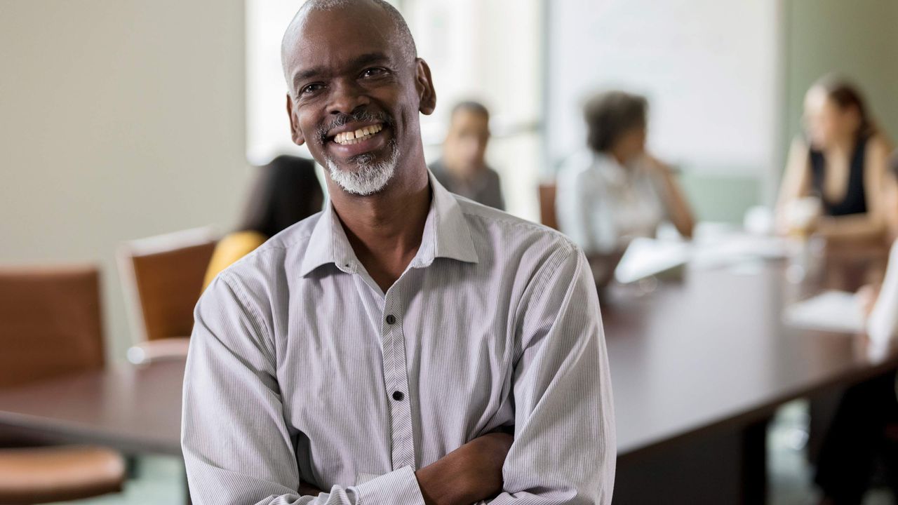 A man attends a meeting in a boardroom.