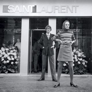 Yves Saint Laurent and a model in front of his first Parisian boutique