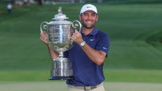 Scottie Scheffler holding the Wanamaker Trophy aloft after winning the PGA Championship in 2025