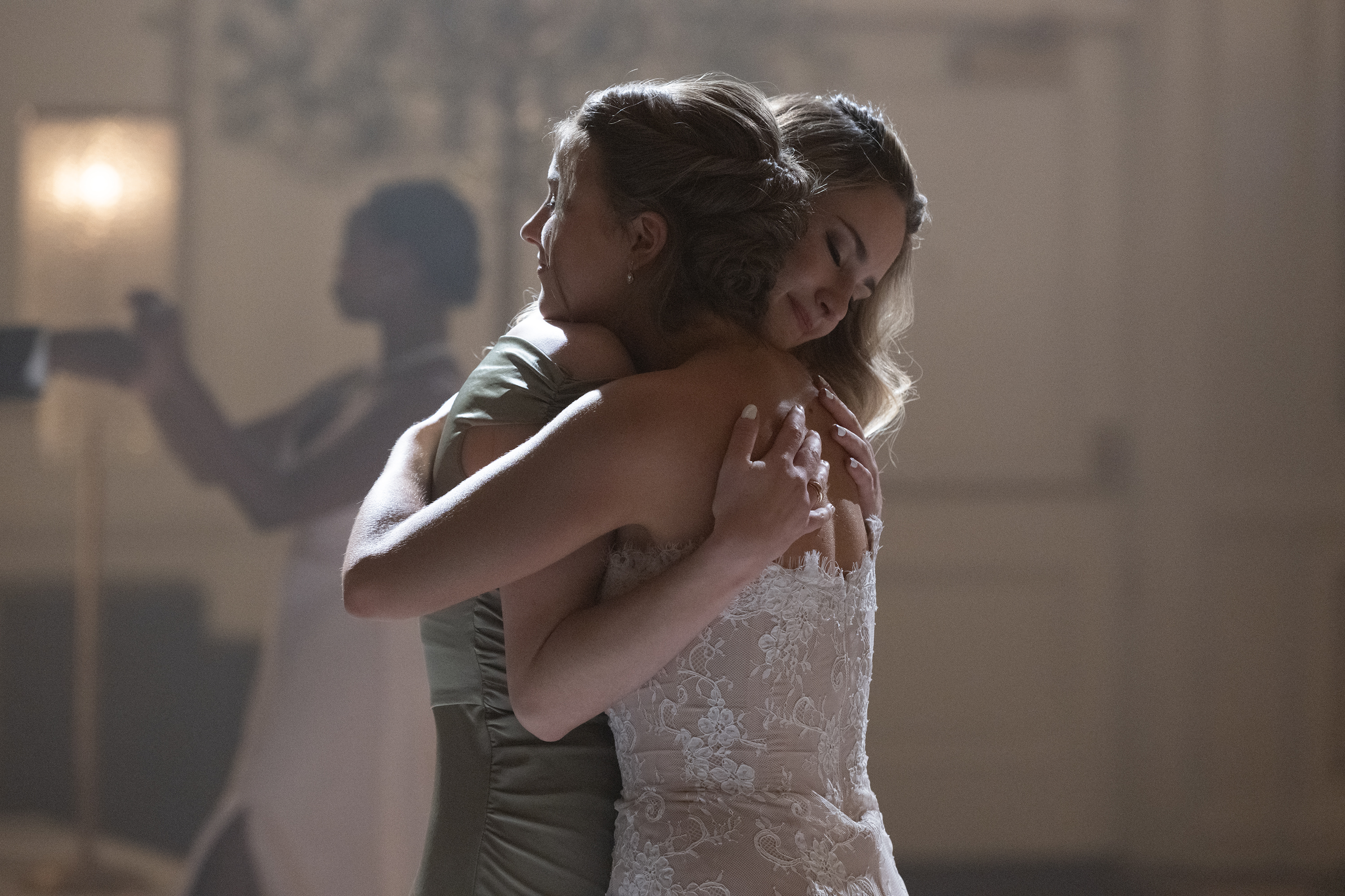 catherine missal as bree in a wedding dress at the center of the dance floor hugging grace van patten as lucy in the season 3 series finale of tell me lies