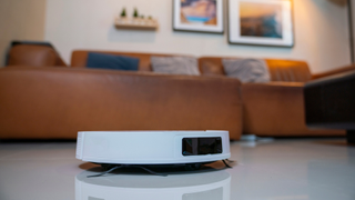 A robot vacuum cleaner pictured on the floor of a family living room