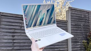 Acer Nitro V 14 Pearl White in hand with outside background