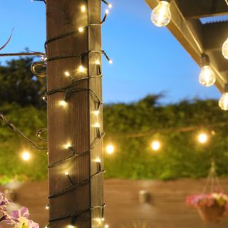 Warm white fairy lights from The Solar Centre wrapped around wooden pergola