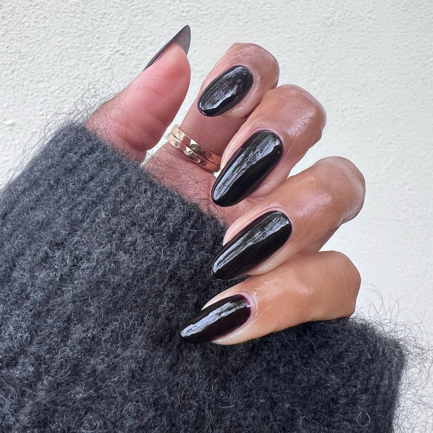 A long, almond-shaped, glossy black manicure