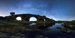 The Milky Way glitters in the predawn sky over Portugal's Guadiana River in this image by astrophotographer Sérgio Conceição. Saturn, Jupiter and the bright star Antares appear embedded in the Milky Way's dusty arc, while the bright star Spica dominates the sky to the right. In the foreground of this photo is the 500-year-old Bridge of Ajuda.