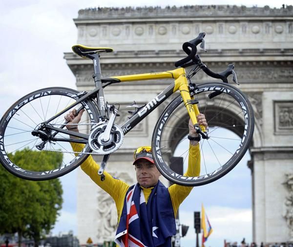 Cadel Evans (BMC) holds aloft his bike