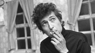 Bob Dylan smoking a cigarette backstage at a gig