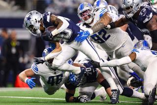 Tony Pollard #20 of the Dallas Cowboys runs the ball during an NFL football game against the Detroit Lions at AT&T Stadium on December 30, 2023