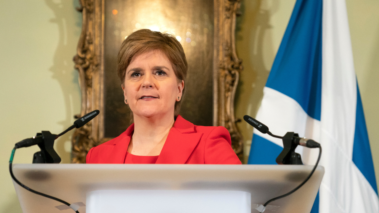 Nicola Sturgeon standing at a lectern 