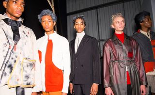 A group of male models modelling various styles of clothing at the London Fashion week.