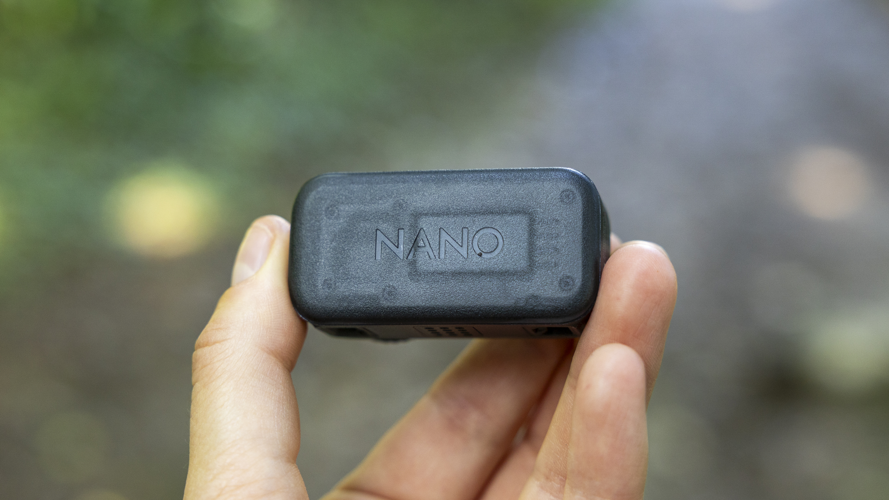 A female photographer holding the DJI Osmo Nano action camera