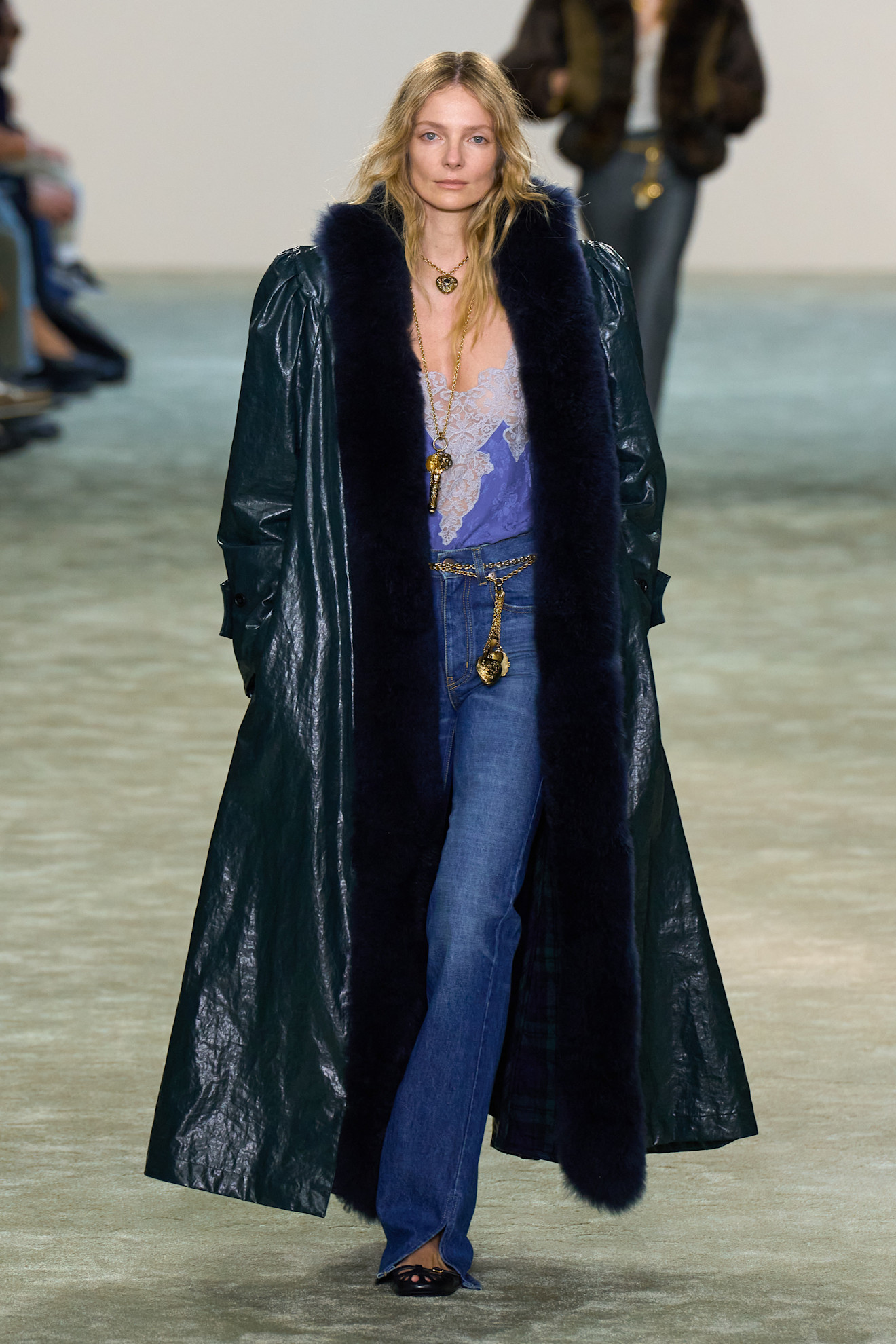 Chloe model in long jacket with wide-leg split-hem jeans.