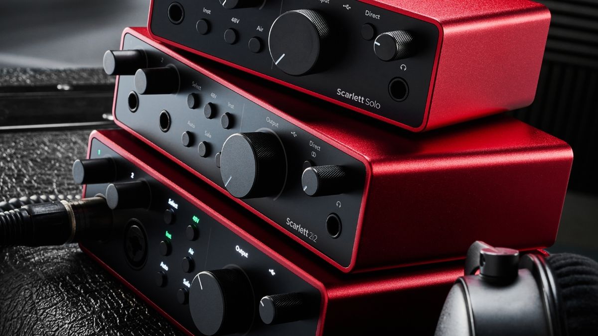 Three Focusrite Scarlett 4th gen audio interfaces stacked on top of each other in a studio