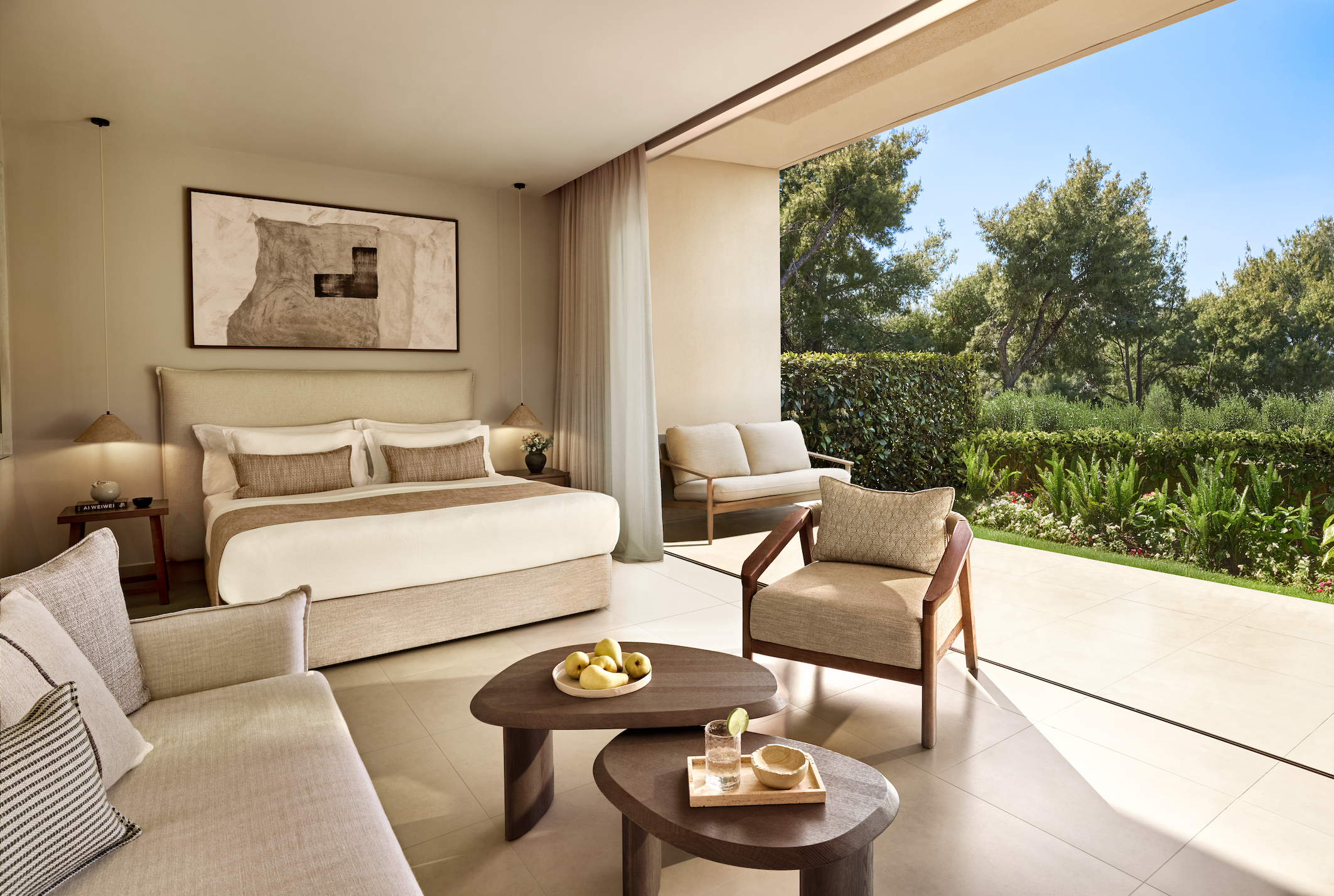 Double hotel room in Sani Club with neutral decor and open patio doors, with a garden view