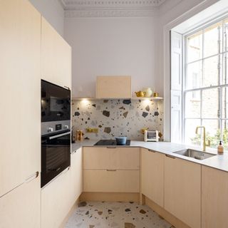 A plywood kitchen with terrazzo tile
