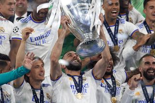 Karim Benzema lifts the Champions League trophy alongside his Real Madrid team-mates after victory over Liverpool in the 2022 final.